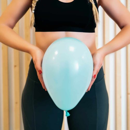 Close,Up,Of,A,Young,Woman,Holding,A,Balloon,To